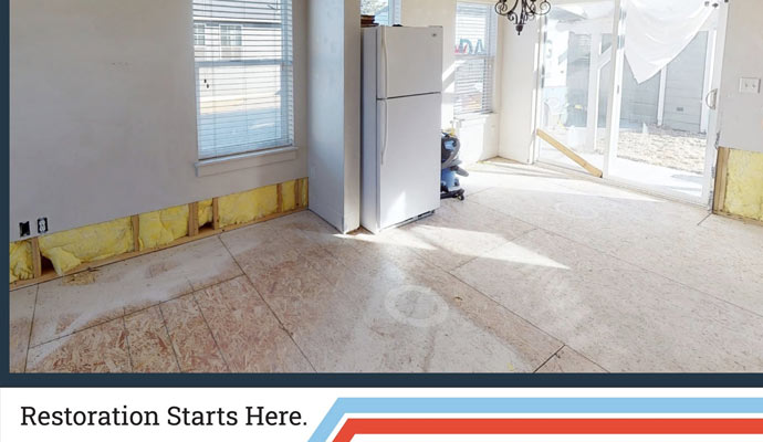 A room with flood cut walls exposed insulation and subfloor
