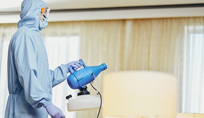 A technician fogging a room for smoke odor removal
