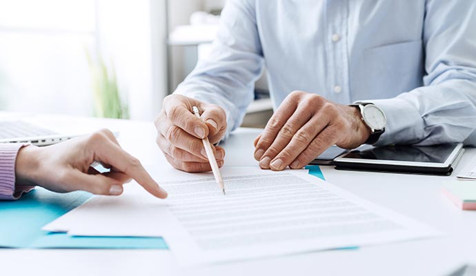 Assistant explaining insurance documents and policy details to client