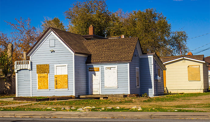 Blue house with boarded windows