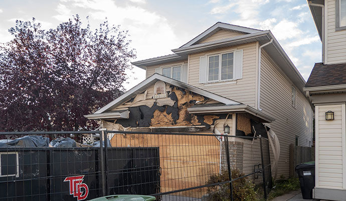 Boarded up fire damaged house