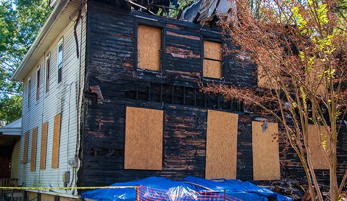 Boarded up fire damaged house