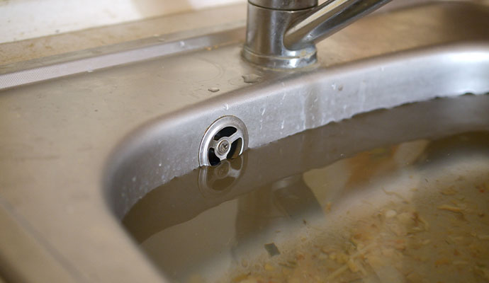 Clogged kitchen sink with standing water