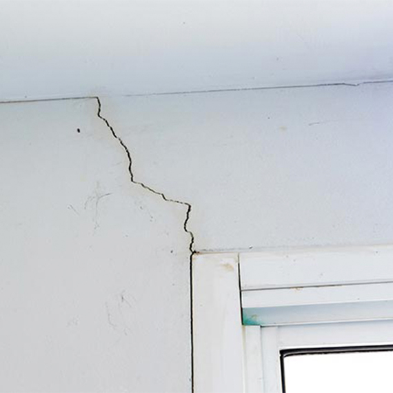 Cracked wall above a window frame