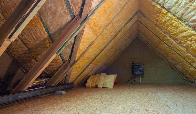 Fiberglass batt insulation installed between attic roof rafters