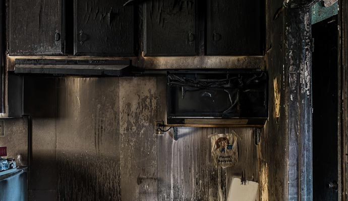 Smoke and soot damaged kitchen property