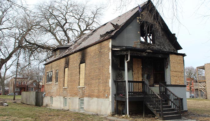 Fire damaged boarded up house