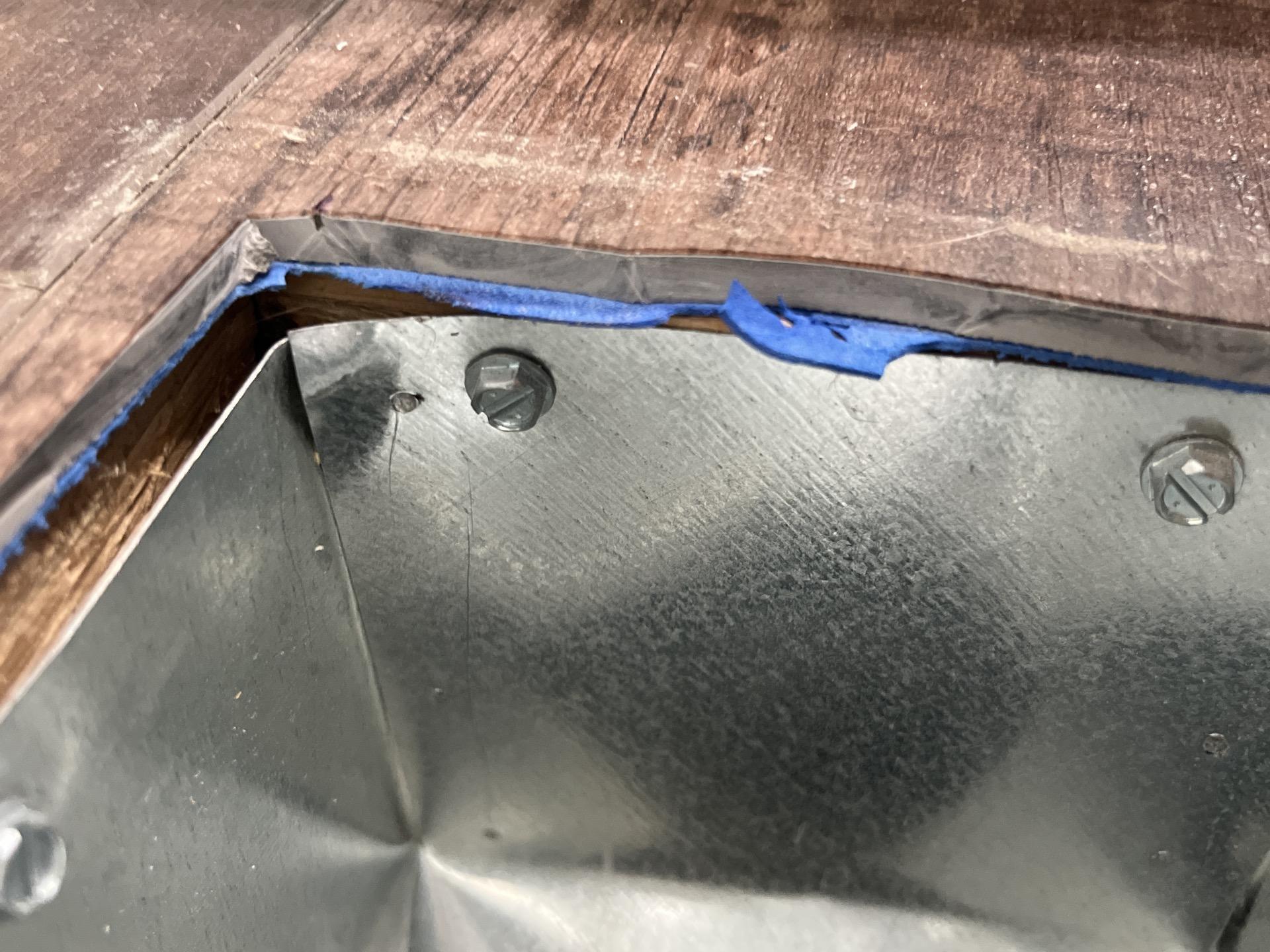 Inspection of subfloor framing and metal HVAC register ductwork following bathroom moisture intrusion.