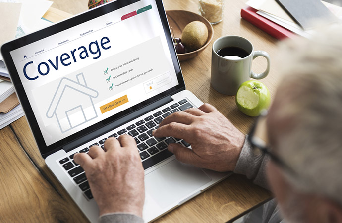 person completing a property coverage insurance policy on computer