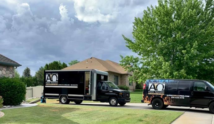 Alpha-Omega Disaster Restoration service trucks parked outside