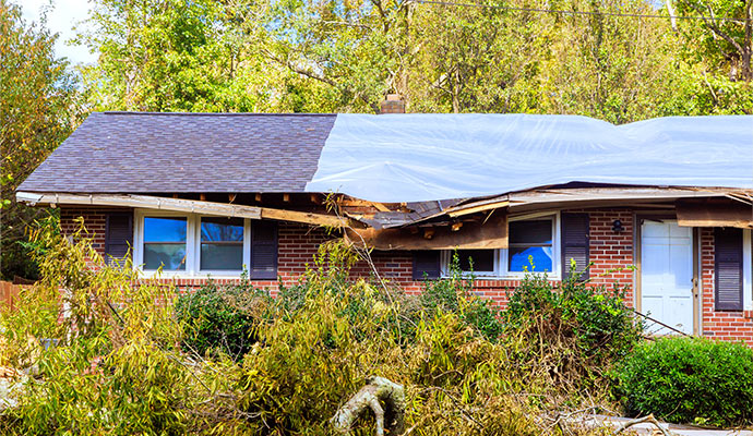 Storm damaged house with tarp