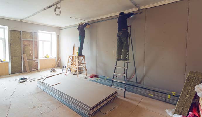 Technicians repairing drywall