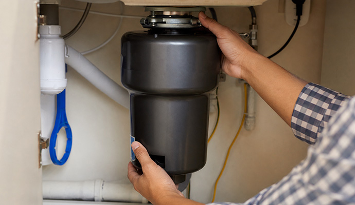A person fixing garbage disposal